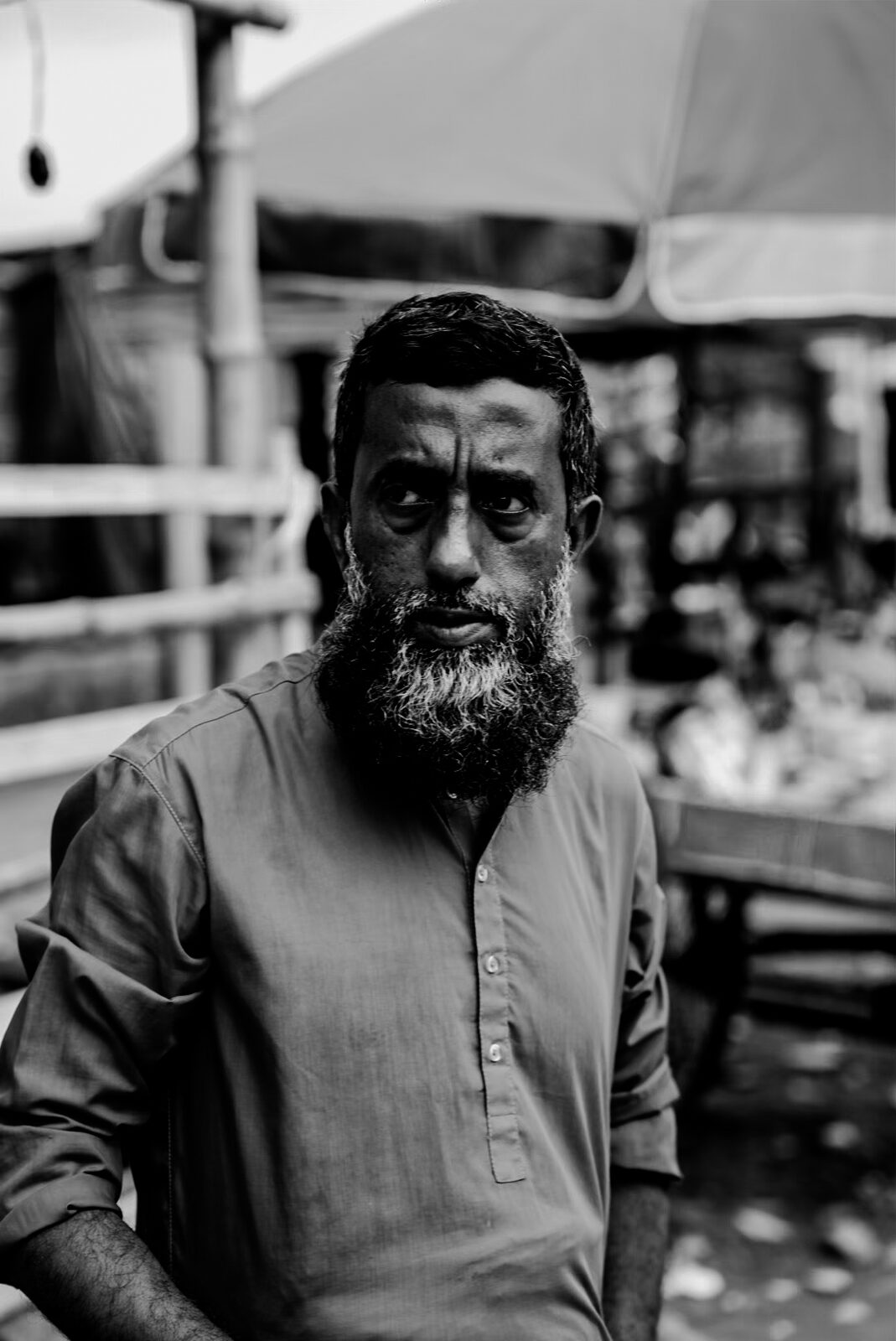 Bearded man portrait under an umbrella stall